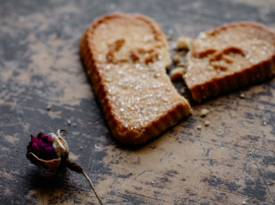 a heart shape broken cookie and a withered rose