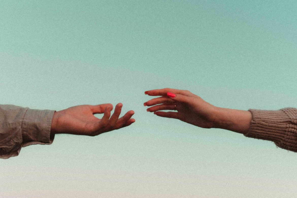 couple's hands reaching out