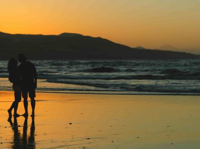 couple watching sunset at the beach