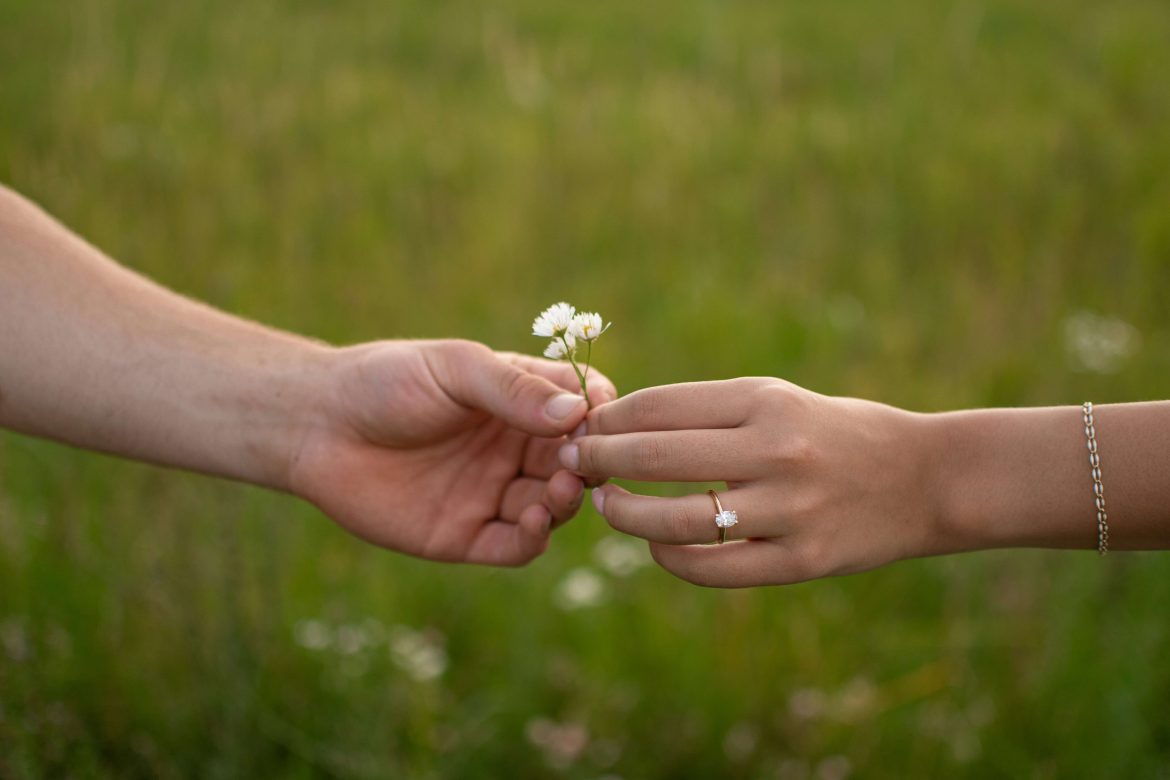 man handing woman a flower